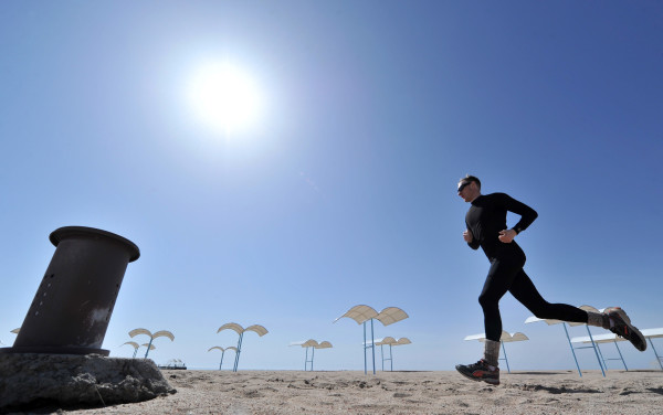 A man jogs on the bank of the Issyk-Kule Lake some 260 km from Bishkek on March 31, 2012. AFP PHOTO/ VYACHESLAV OSELEDKO (Photo credit should read VYACHESLAV OSELEDKO/AFP/Getty Images)