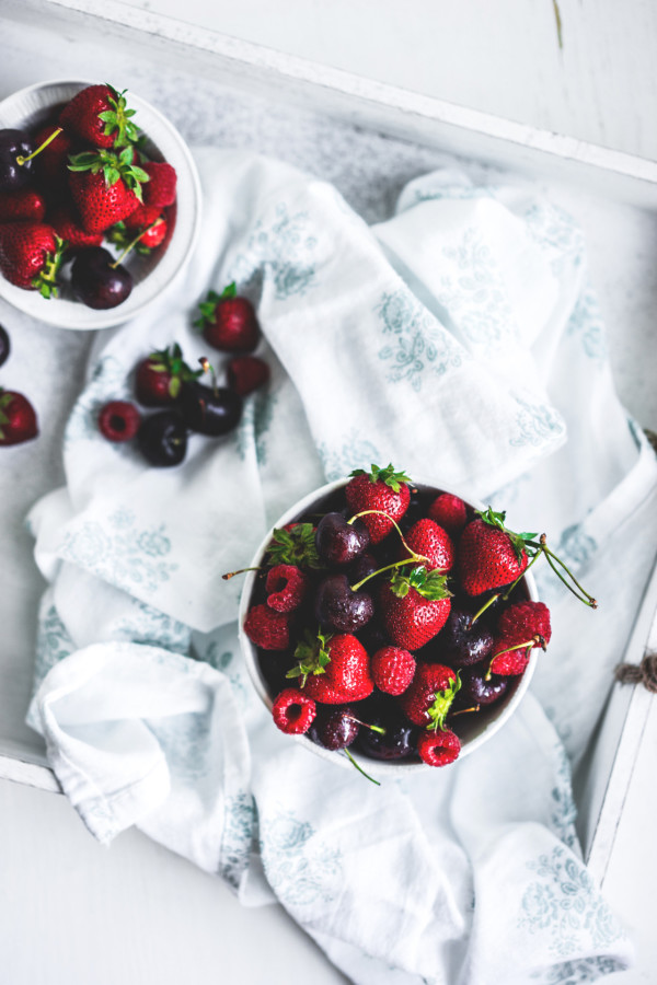 Mix of berries on white rustic background