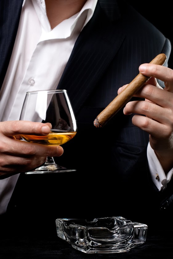 Man smoking cigar and drink cognac