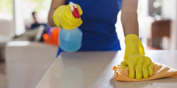 Woman cleaning kitchen counter