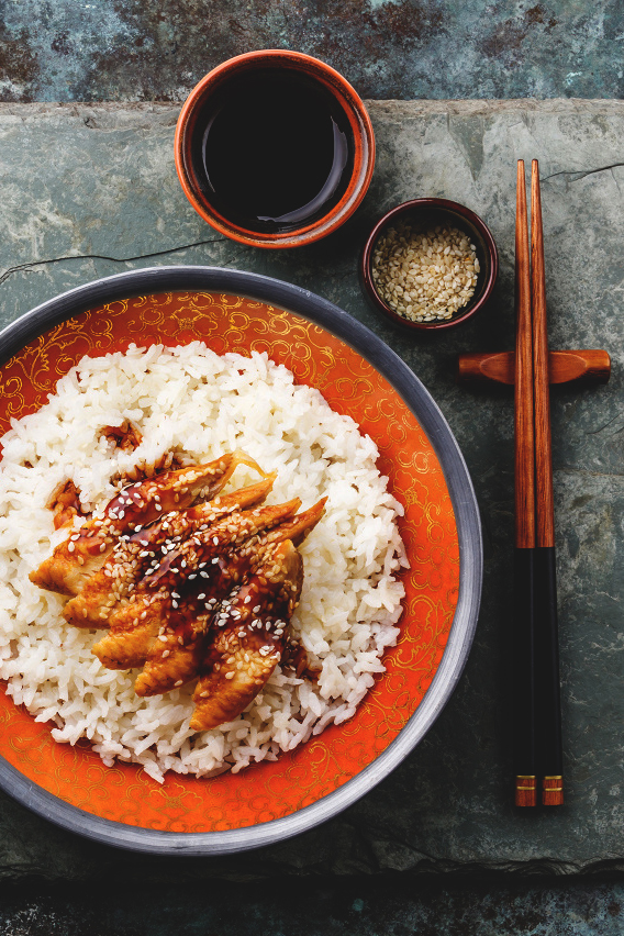 Eel with sauce and sesame on Rice and green tea on stone slate background