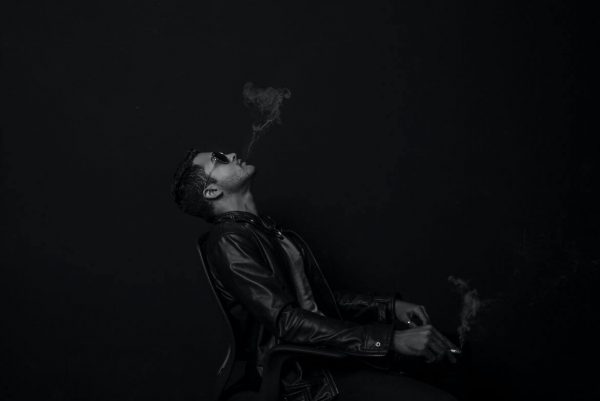 Man in leather smoking 